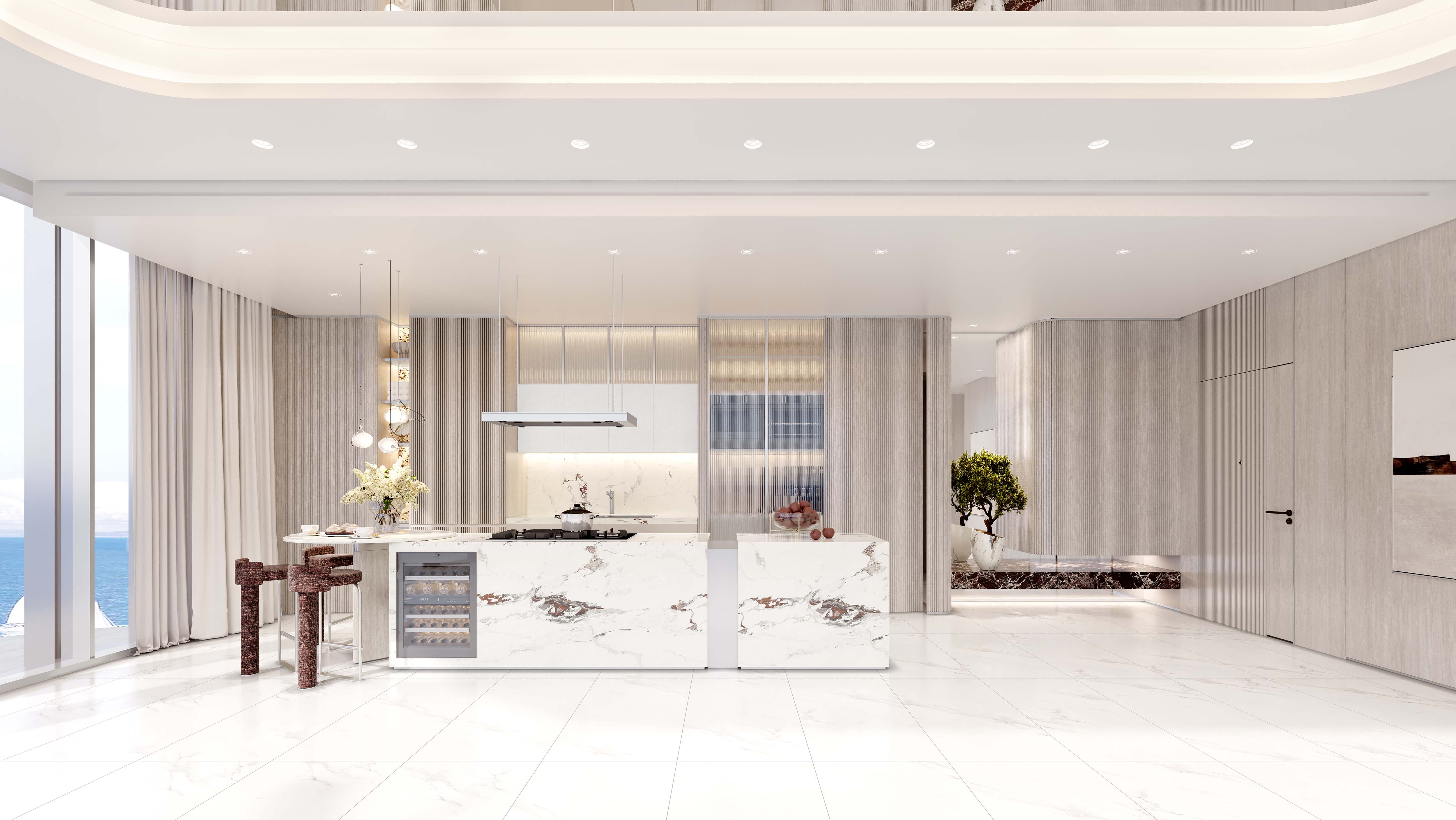 Cotier House 2 By Imtiaz A modern kitchen with marble surfaces, elegant cabinetry, and ocean views, accentuated by stylish decor and lighting.